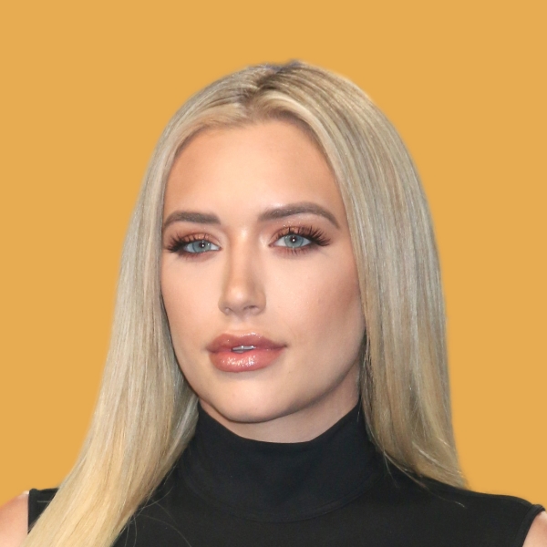 A woman with blonde hair and blue eyes is posing for a photo.