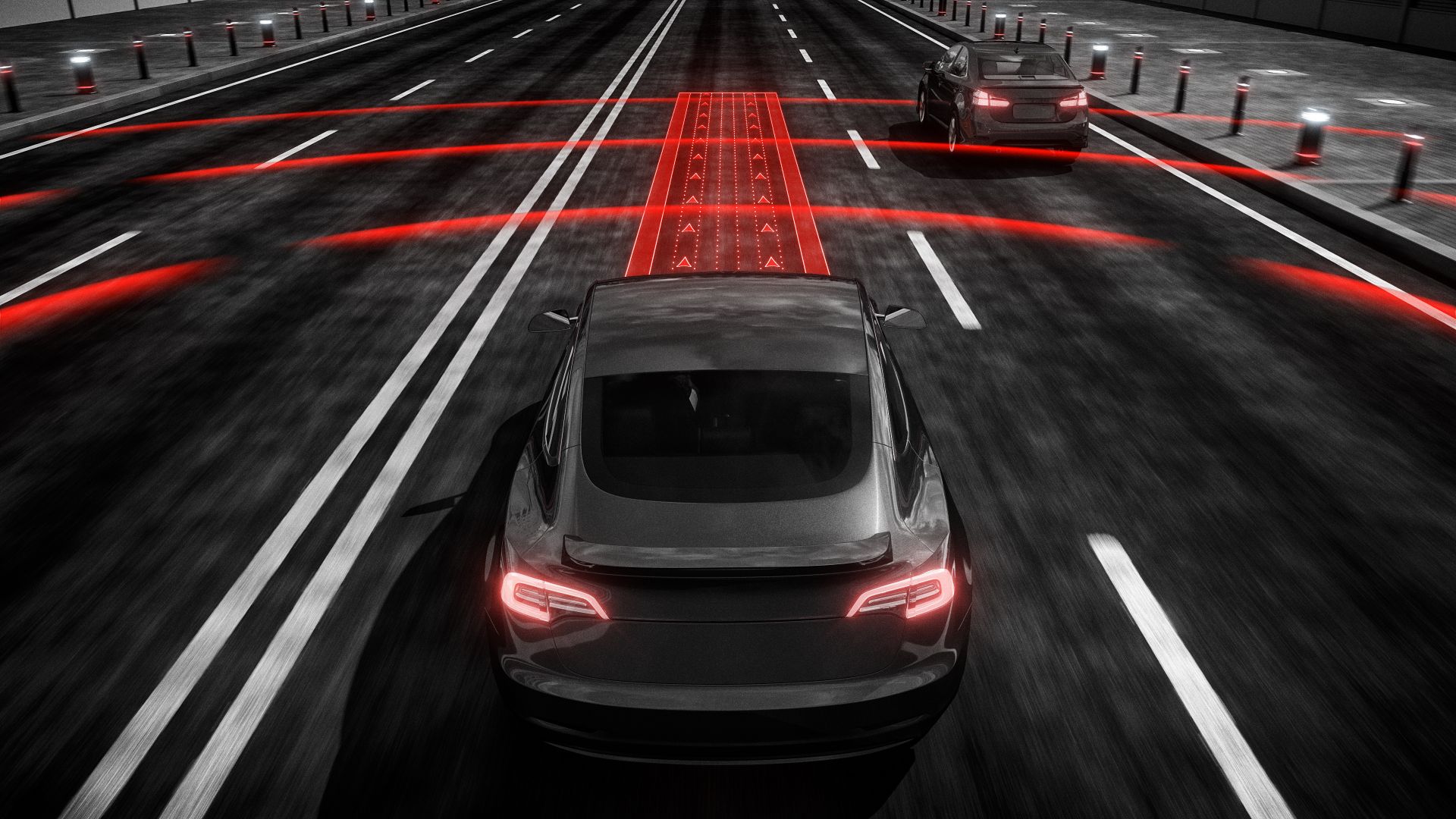 a car driving down a highway with red lights.
