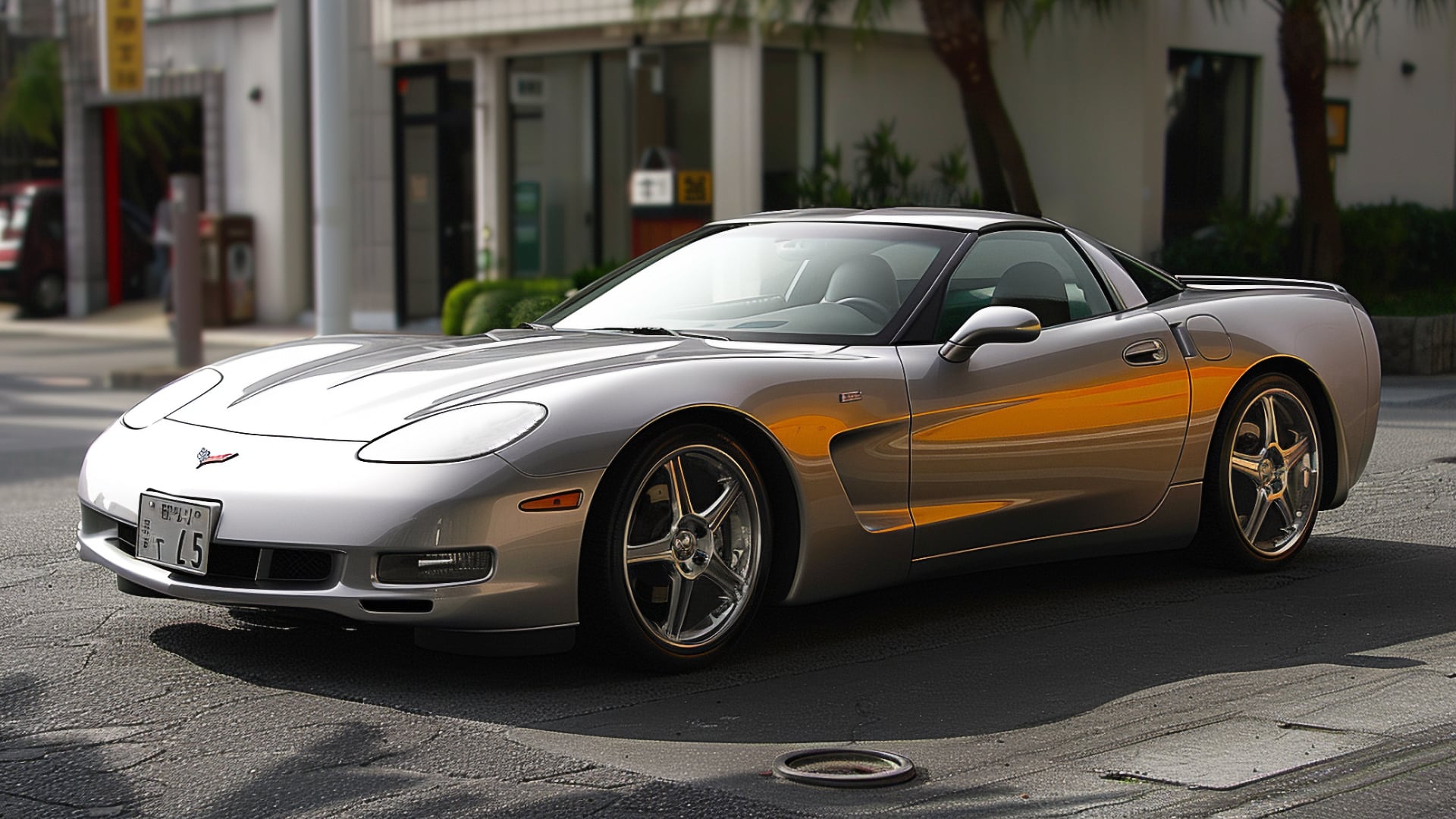 A silver Chevrolet Corvette C5 parked on a street, years to avoid.|a yellow sports car parked on the side of the road.