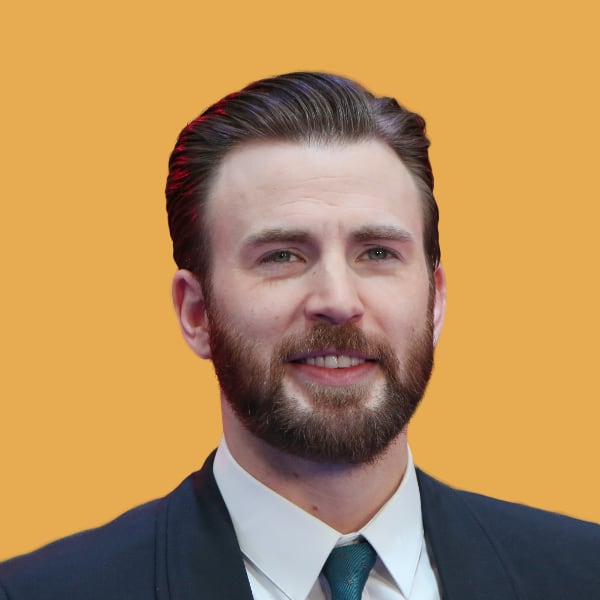 a man with a beard wearing a suit and tie.|a white car parked in front of a mountain.