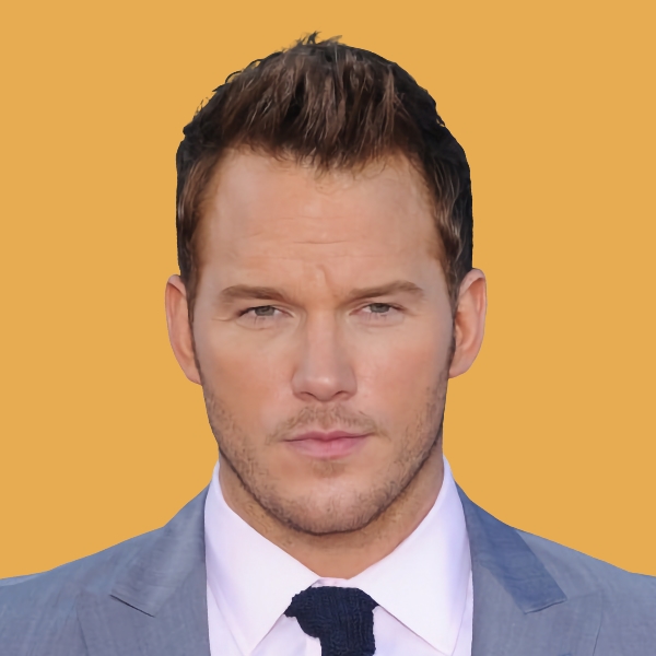 A man in a suit and tie with a yellow background.|an old vw bug parked on the side of the road.