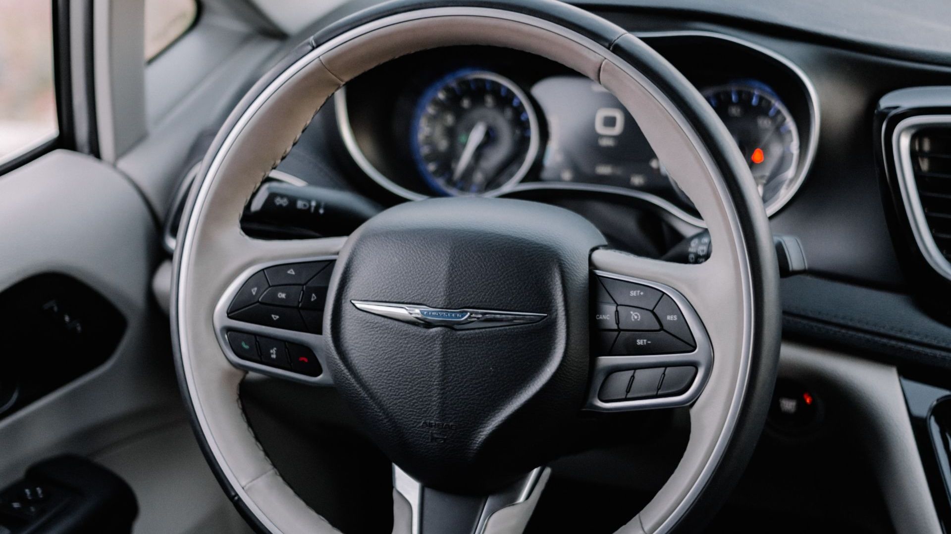 the interior of a car with a steering wheel and dashboard.