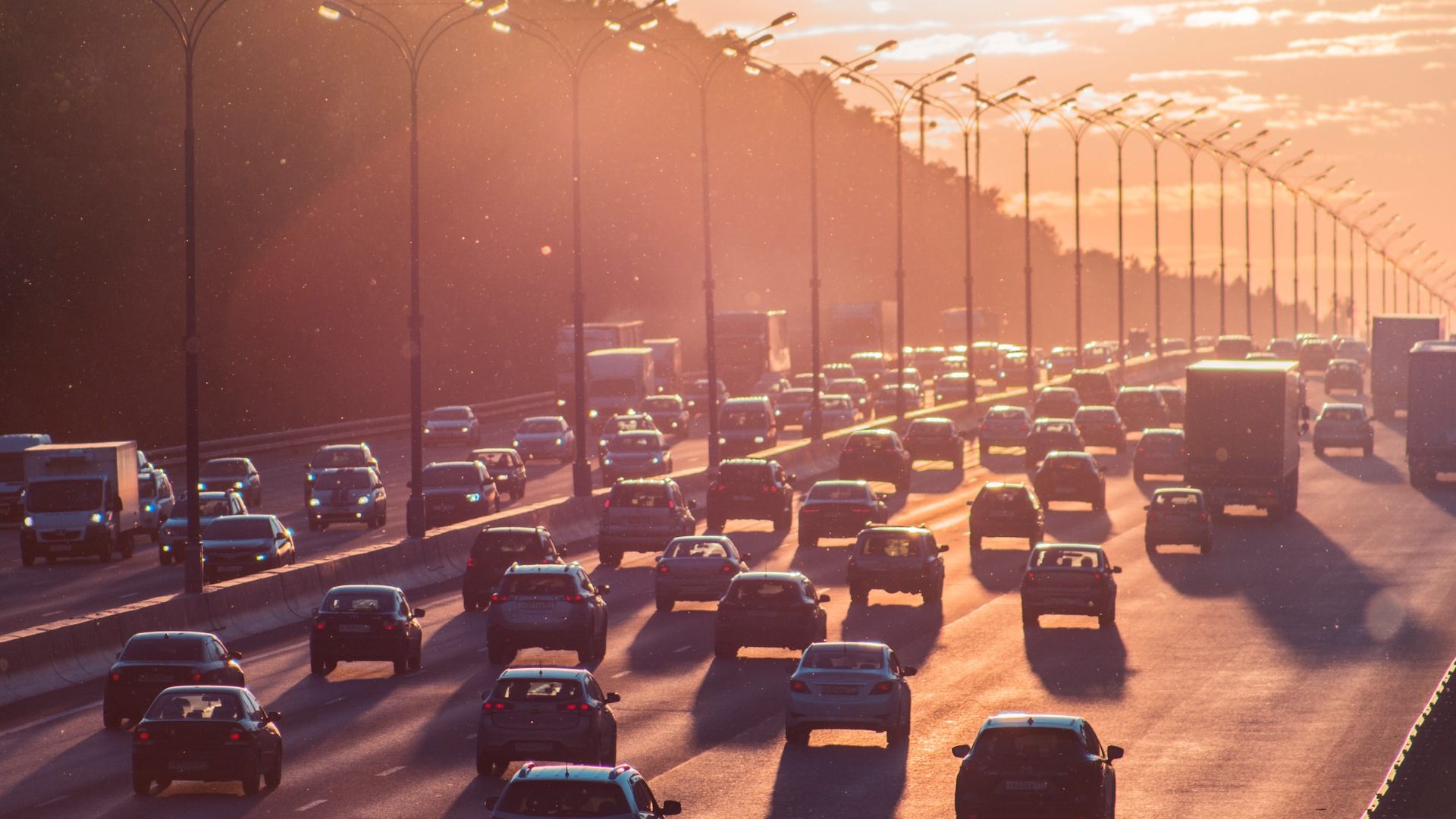 a highway filled with lots of traffic on a sunny day.