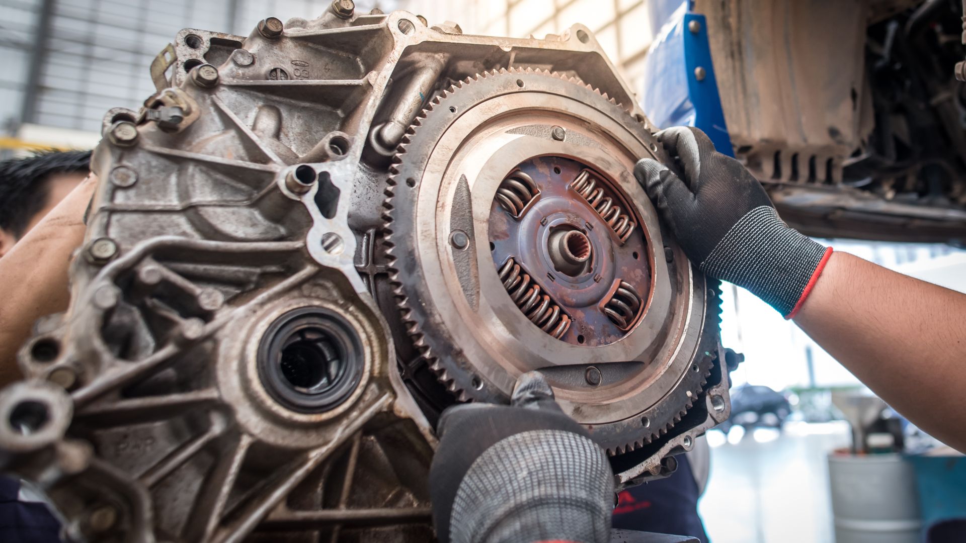 a man working on an engine in a garage.