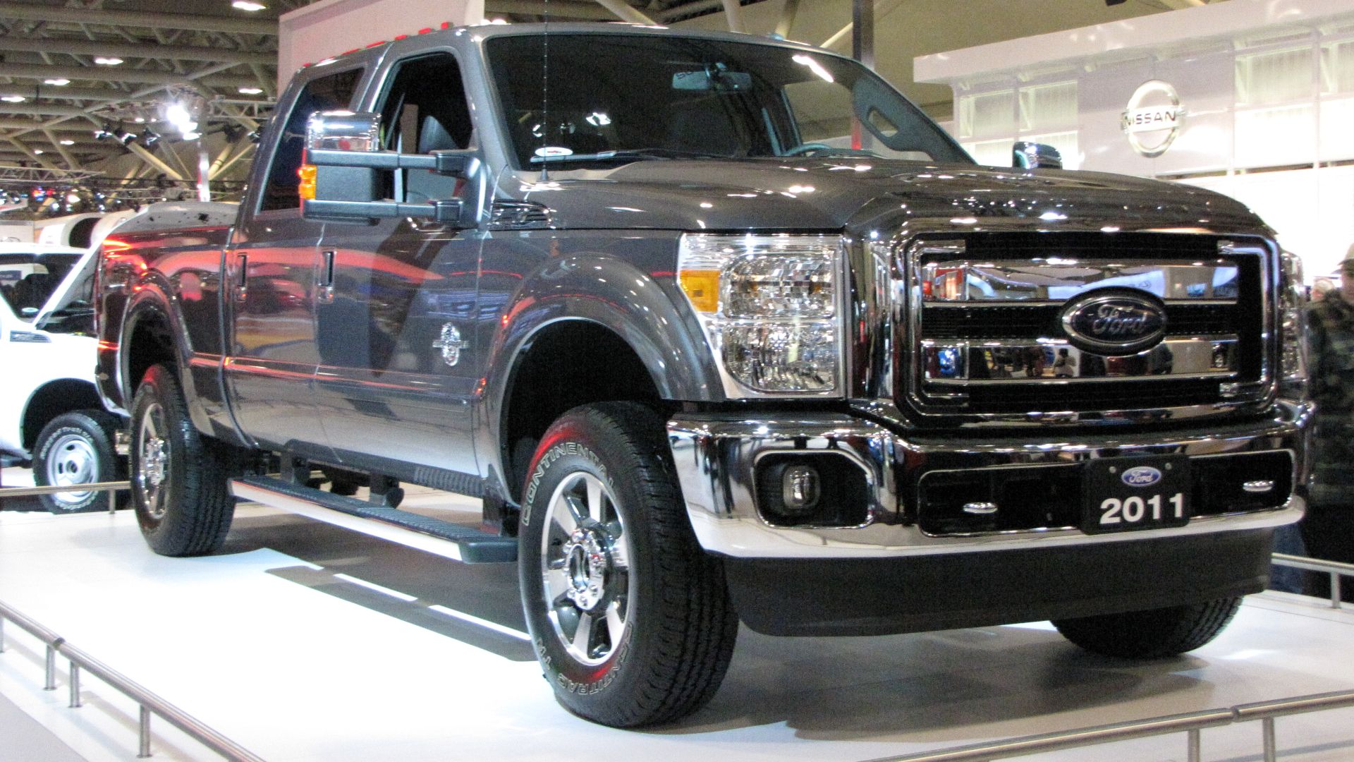 a silver truck is on display at a show.
