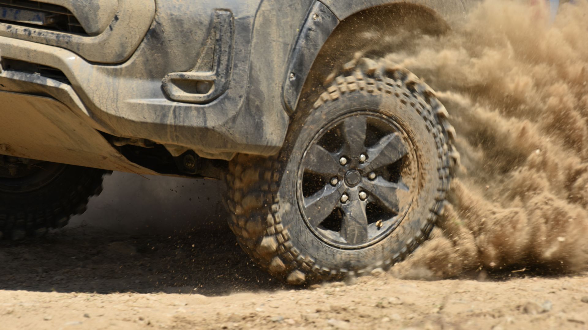 a truck is driving through the mud in the desert.