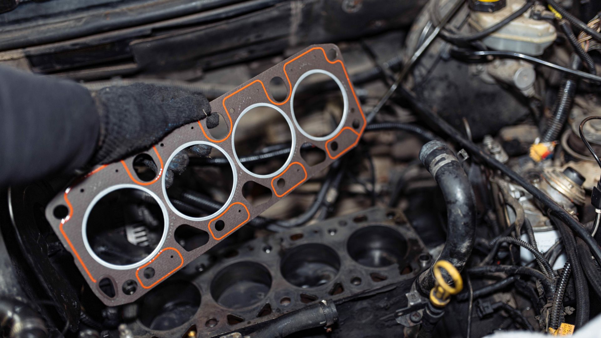 a close up of a car engine with a person working on it.