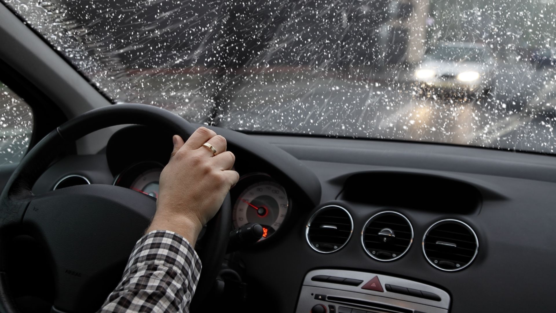 a person driving a car in the rain.