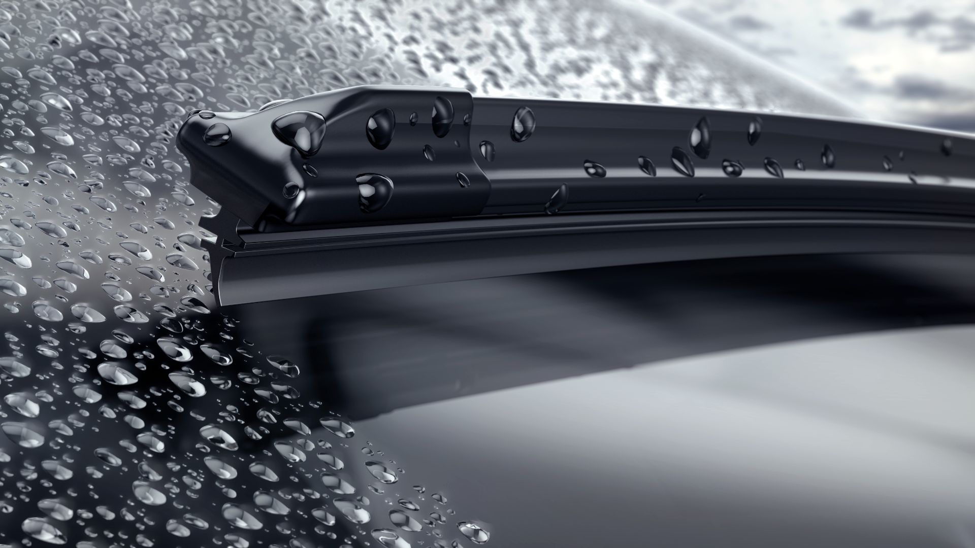 rain drops on the windshield of a car.|a person is holding a car door handle.