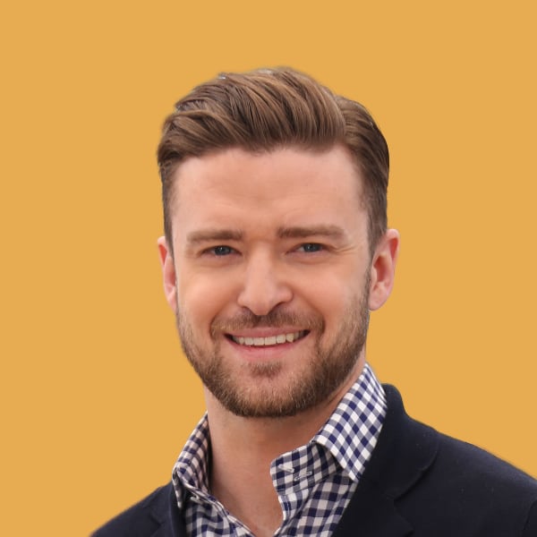 a man with a beard smiling at the camera.