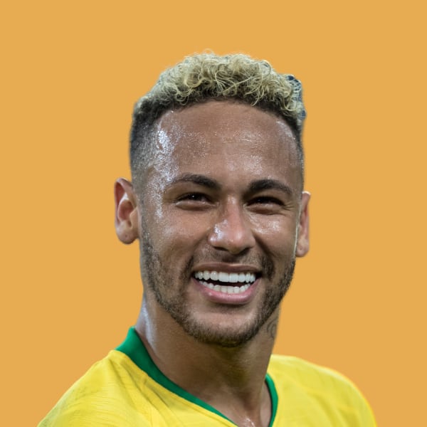 a man in a yellow shirt smiling at the camera.