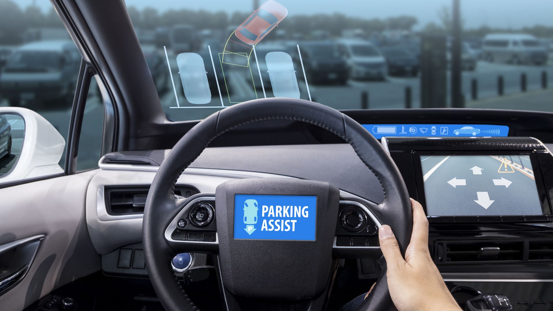 a person driving a car with a parking assist sticker on the dashboard.|a white suv parked in a parking lot.