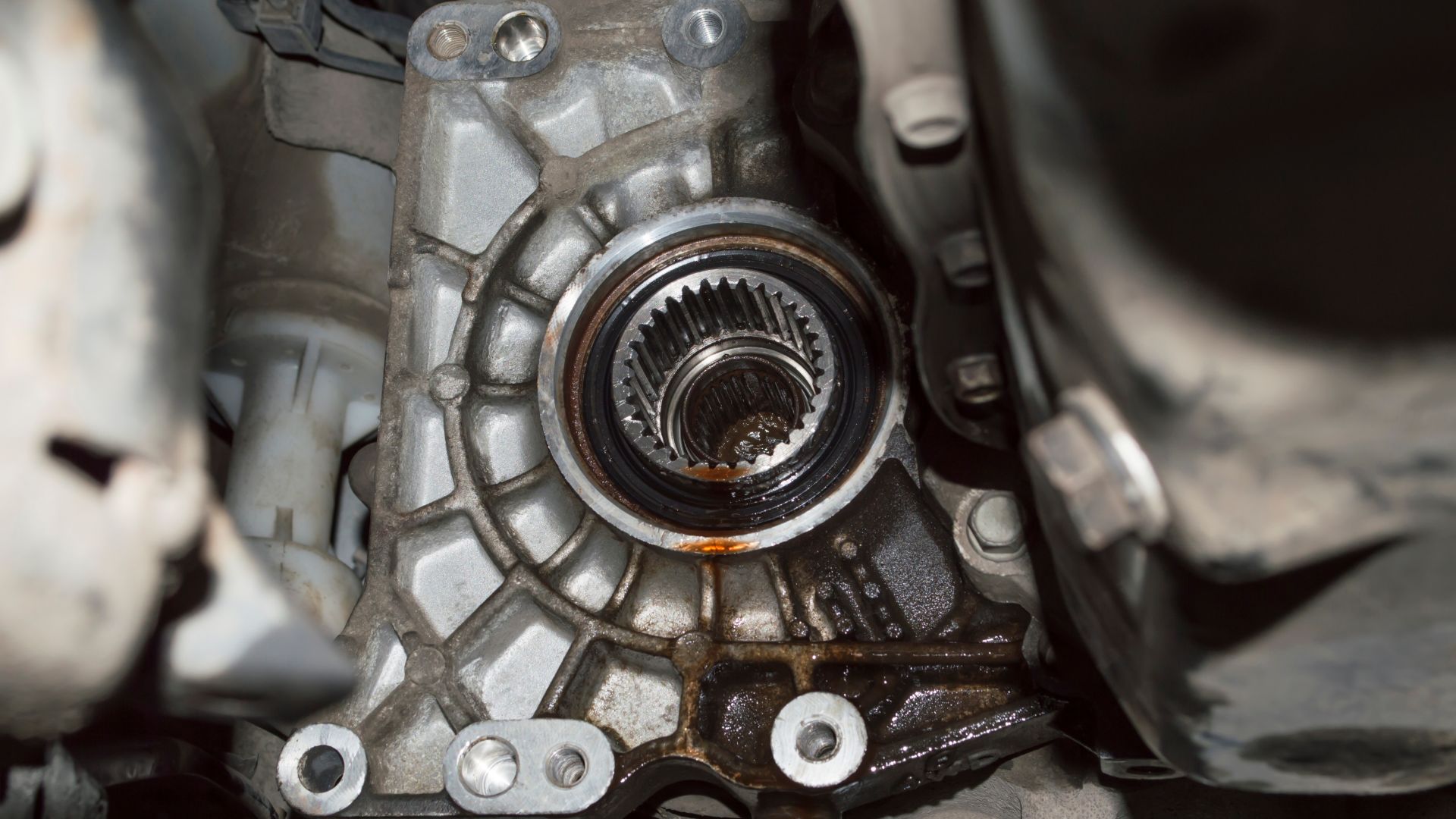 a close up of a metal part of a vehicle.|a close up of a speedometer with a red needle.