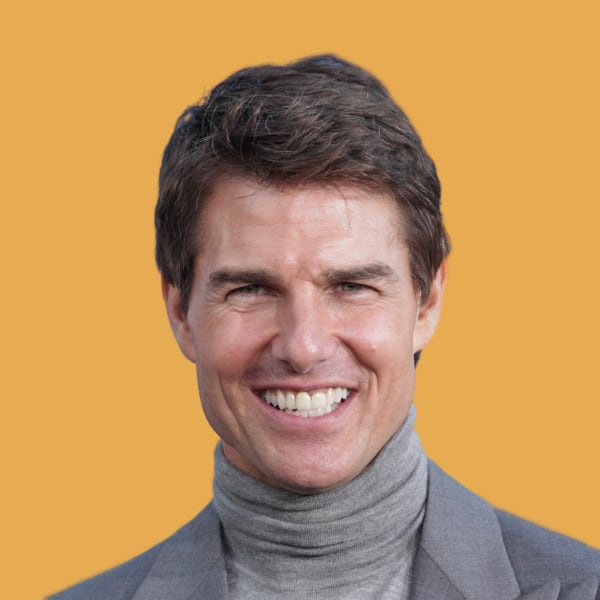 a man in a gray suit smiling at the camera.|a white truck parked in a parking lot.