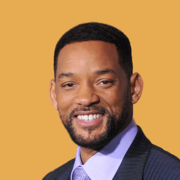 a man in a suit and tie smiling at the camera.