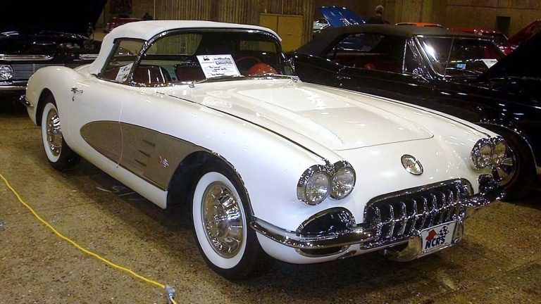 a white and black car is on display at a car show.