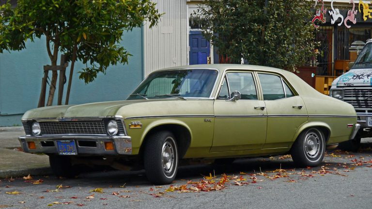 a green car parked on the side of the road.