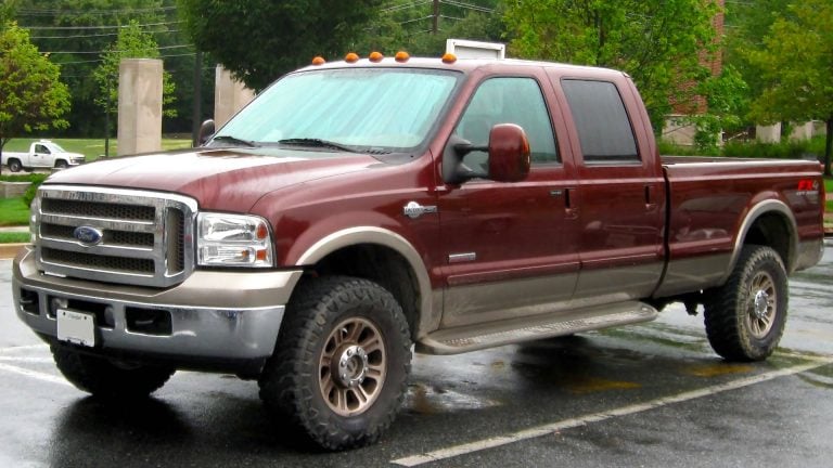 a red pick up truck parked in a parking lot.