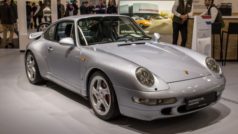 a silver sports car on display at a car show.