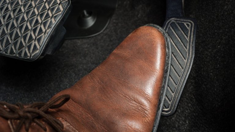 a pair of brown shoes sitting on top of a floor.