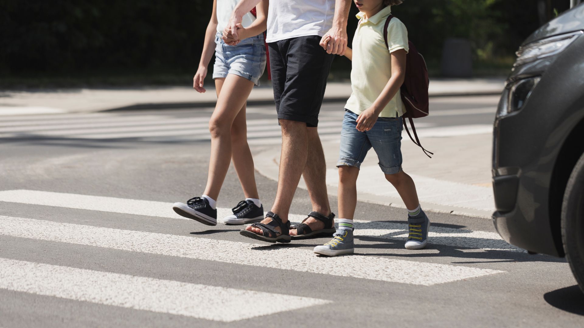 a man and a little girl crossing the street.