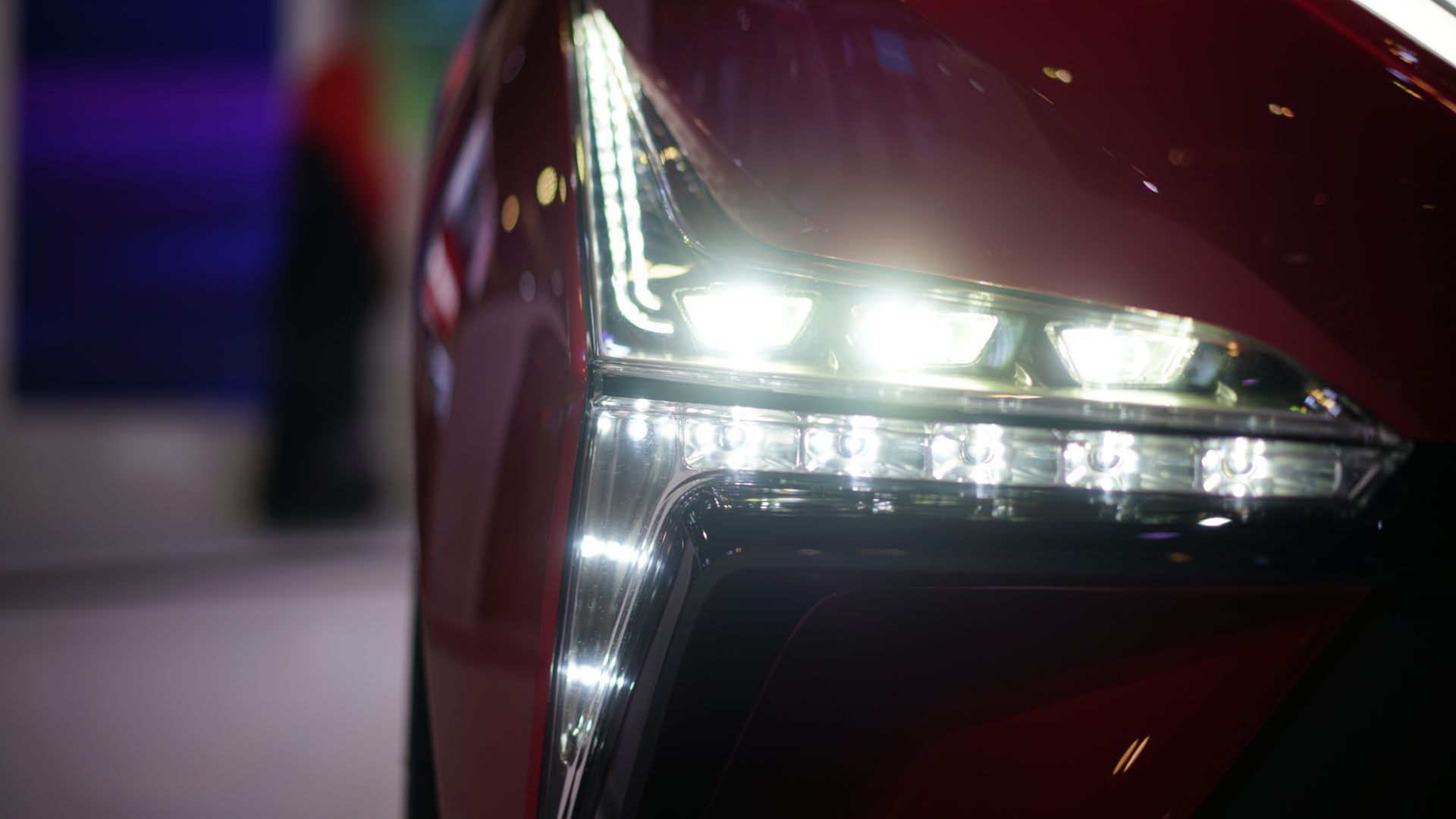 a close up of a red car headlight.