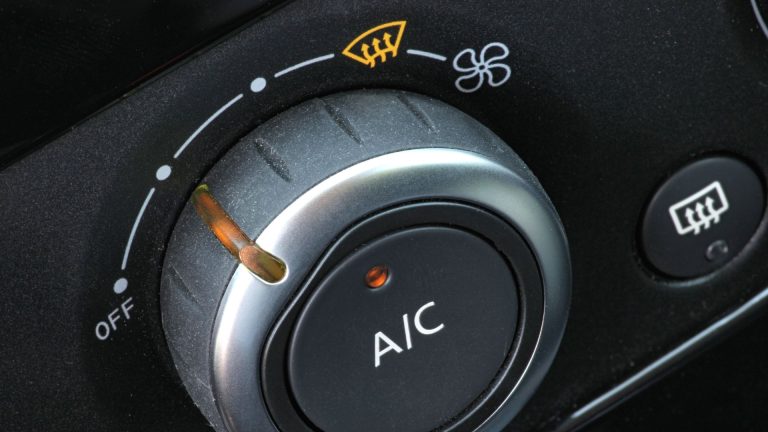 a close up of a button on a car.