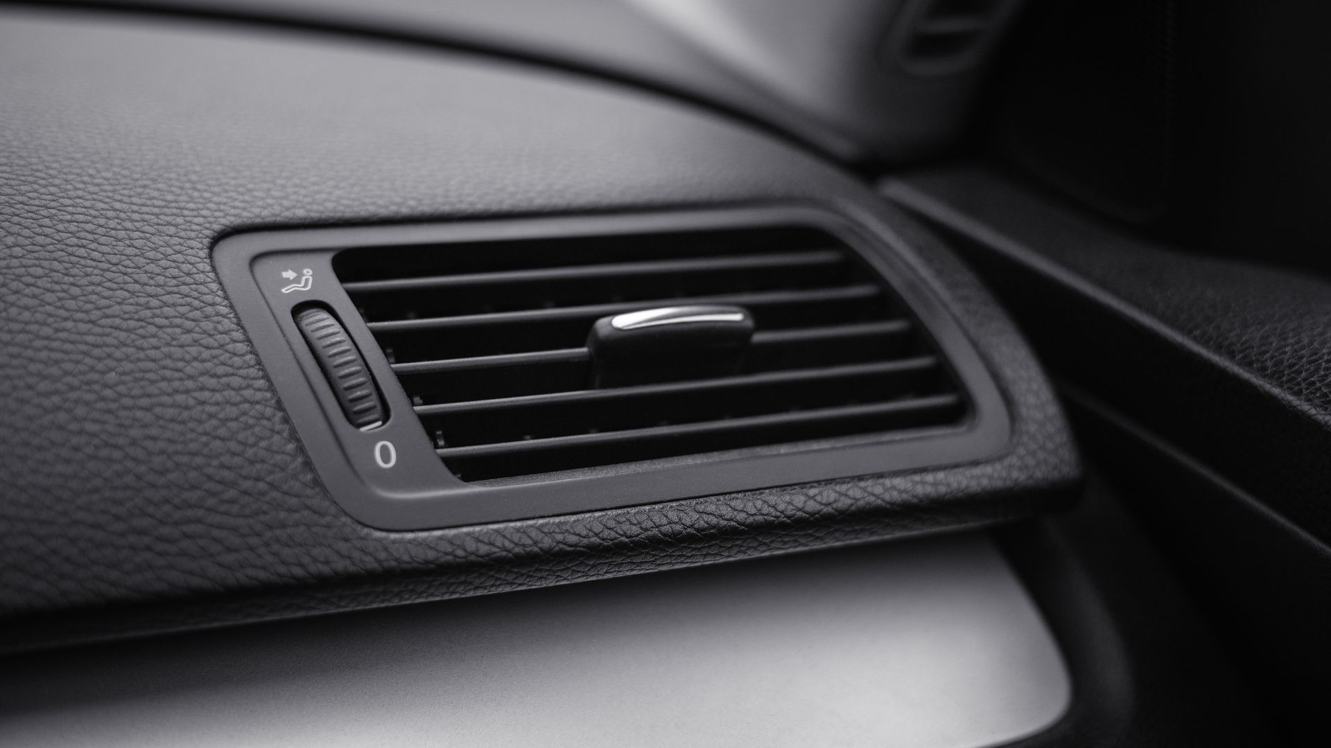 a close up of a air vent in a car.