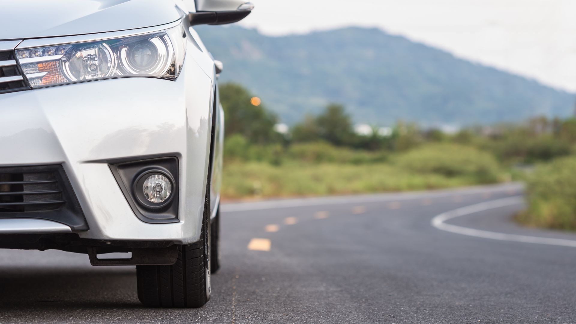 a close up of the front of a white car.