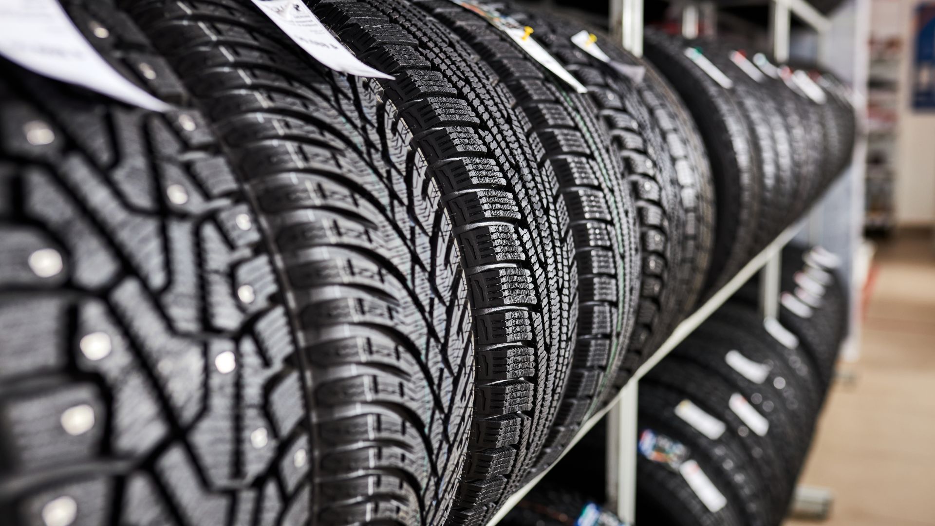 a row of tires on a rack in a store.