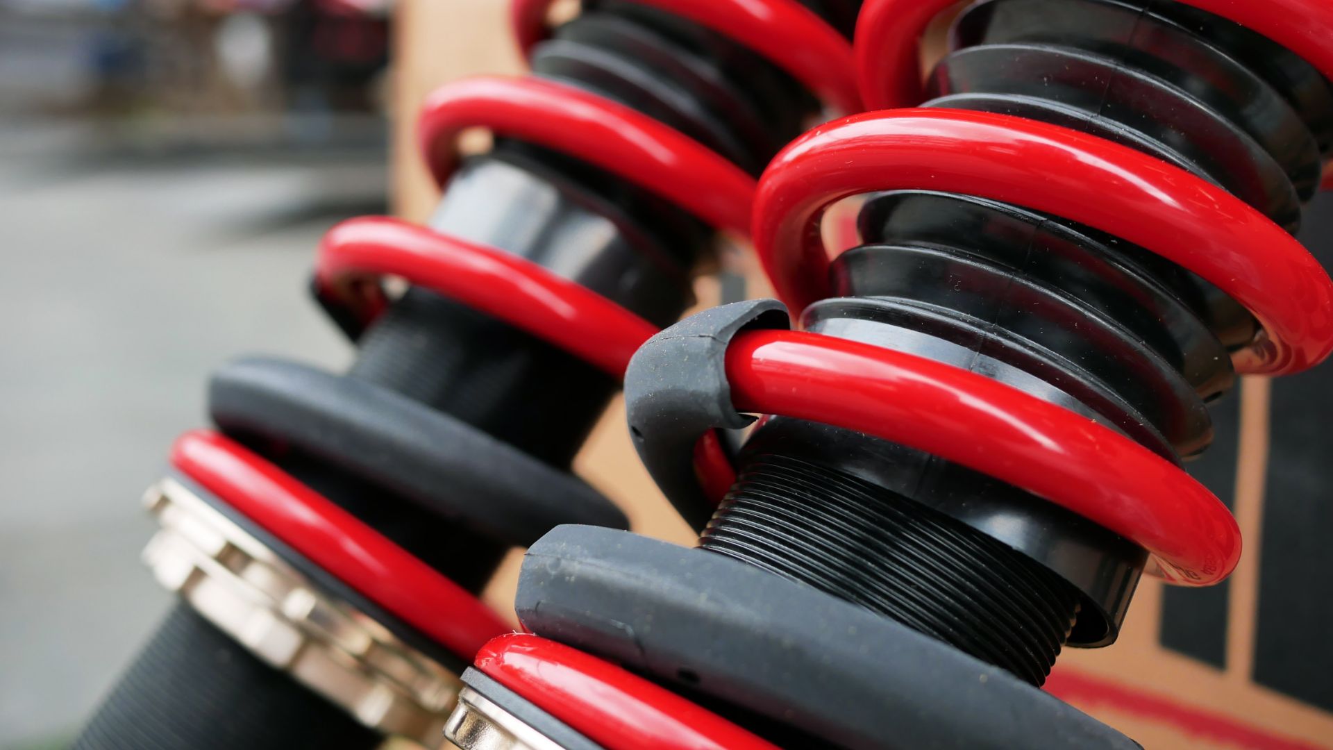 a close up of some red springs on a skateboard.