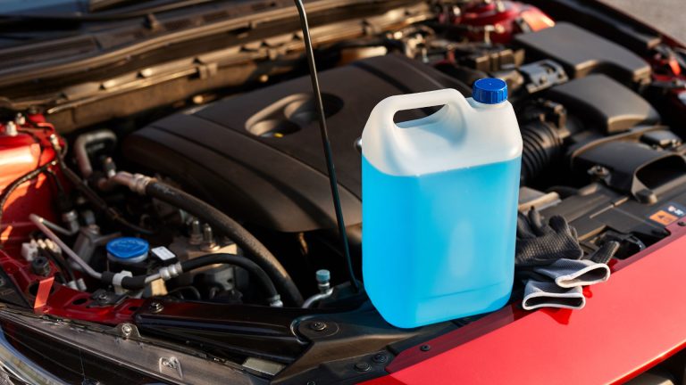 a blue canister sitting on top of a red car.