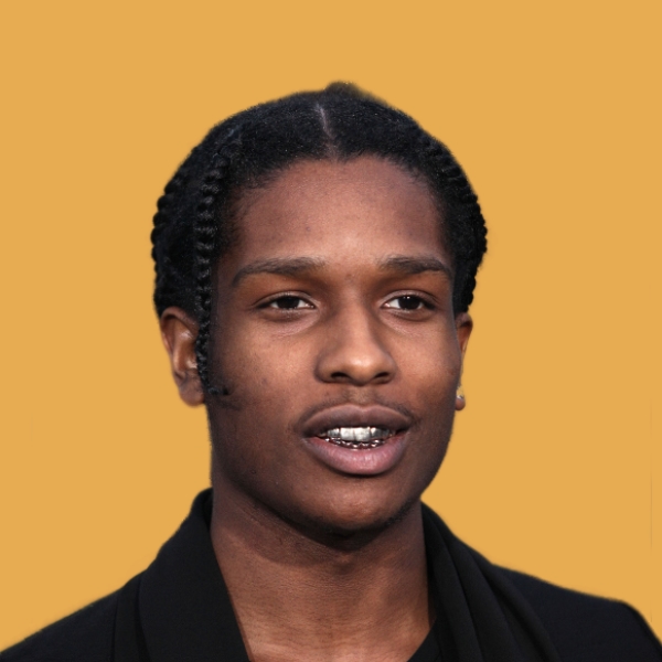 A black man with dreadlocks and a yellow background.