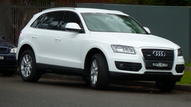 a white car parked on the side of the road.