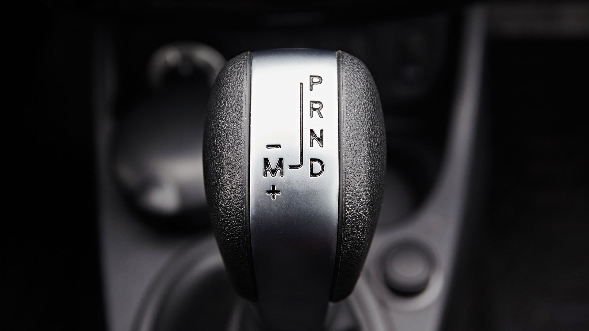 a close up of a car's gear stick.