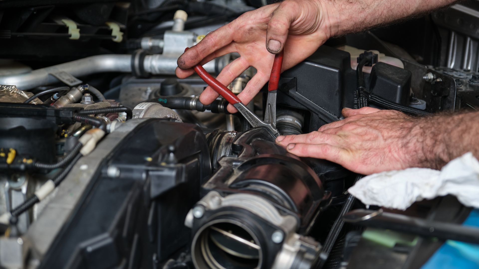 a man is working on a car engine.