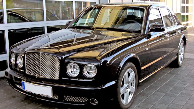 a black car parked in front of a building.