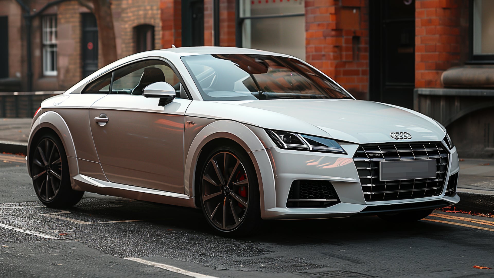 A white Audi TT, from one of the years to avoid, parked on the side of a street.