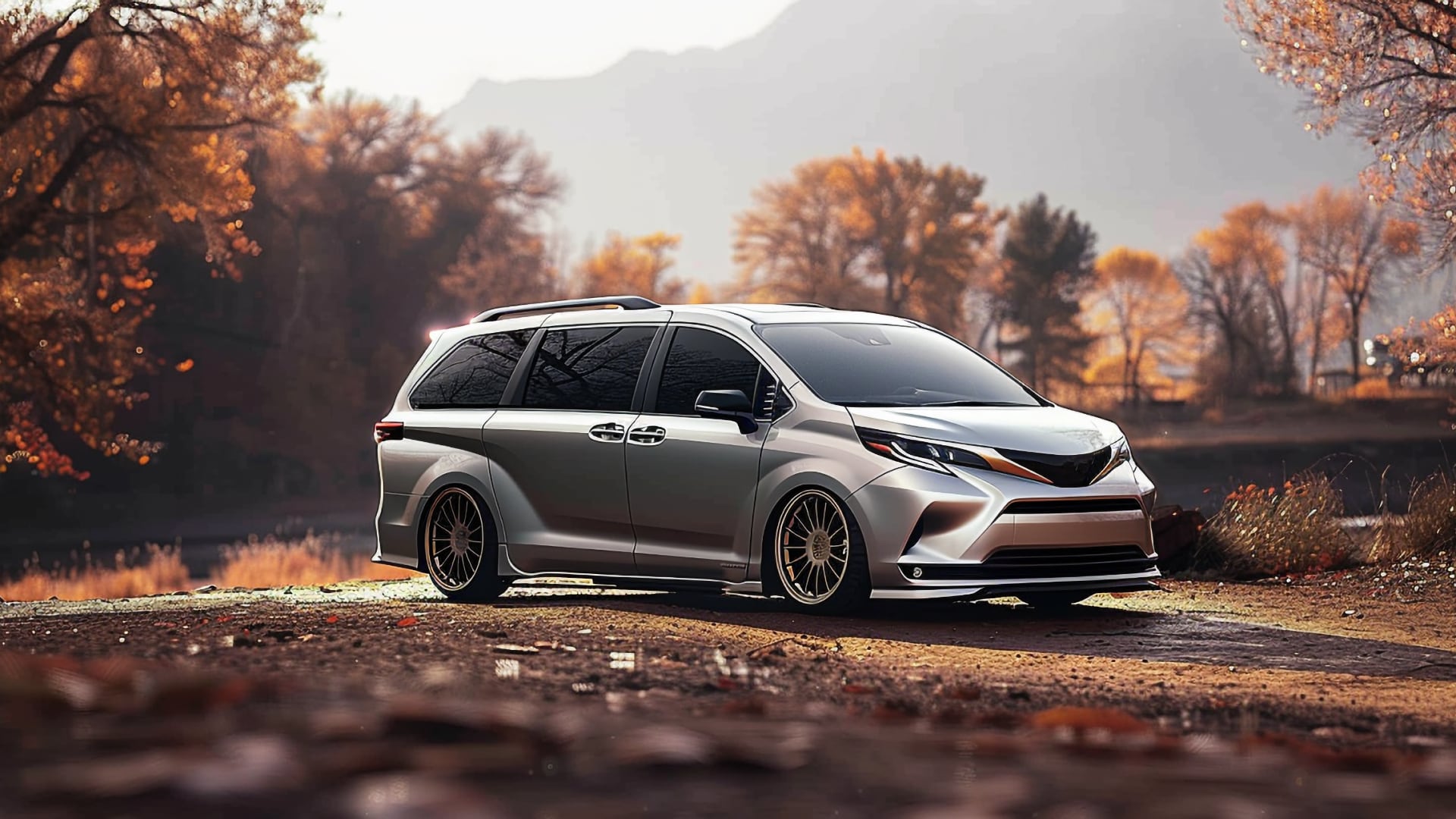A silver Toyota Sienna, a model from the years to avoid, is parked on the side of a road.