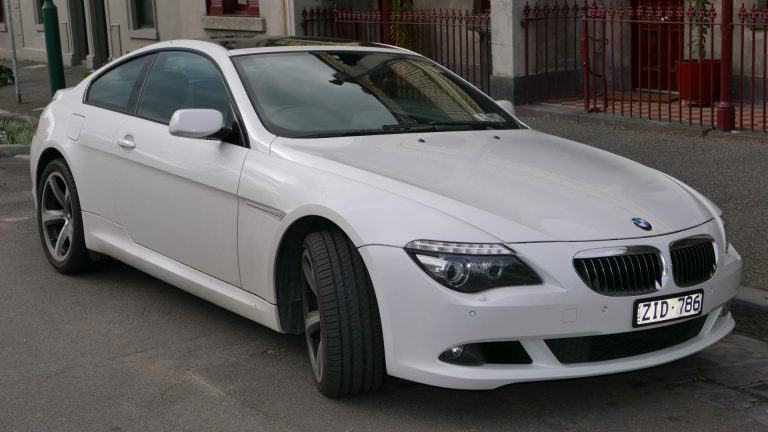 a white car parked on the side of the road.