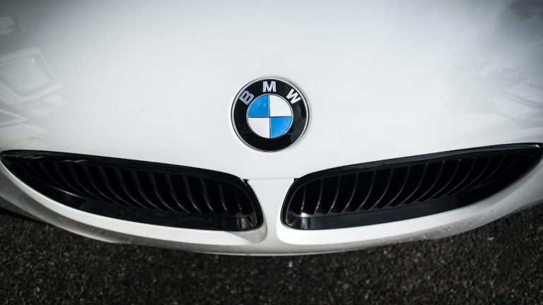 the front end of a white bmw car.