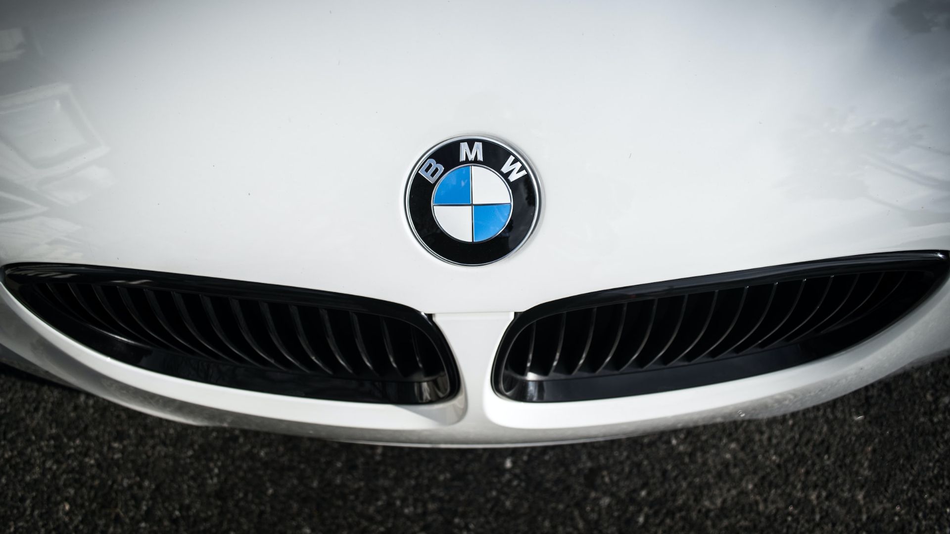 the front end of a white bmw car.