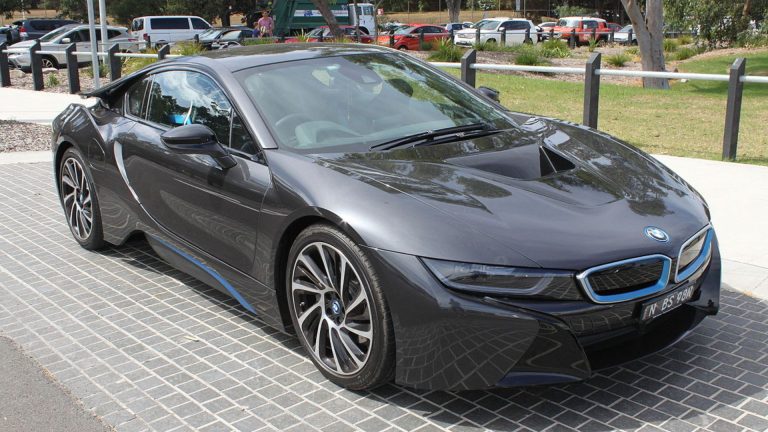 a black bmw sports car parked on the side of the road.