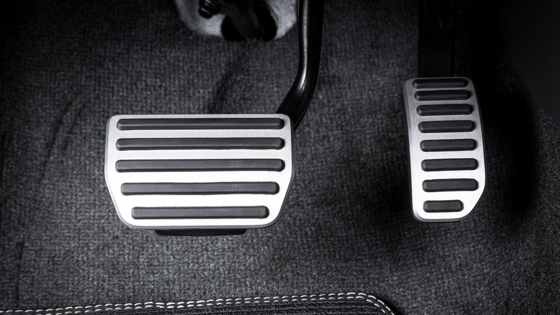 a black and white photo of a pair of foot pedals.