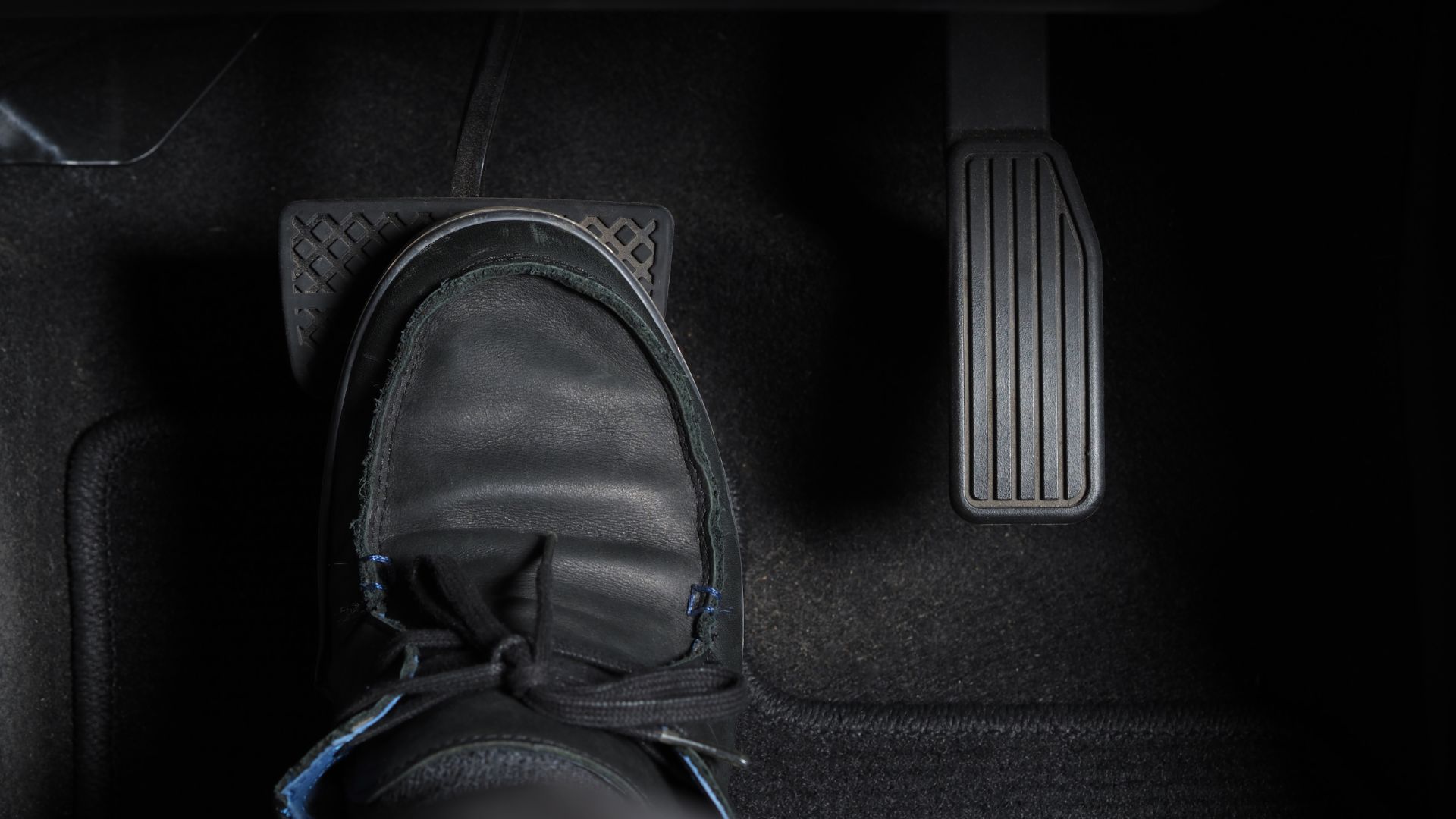 a pair of shoes sitting on the floor of a car.