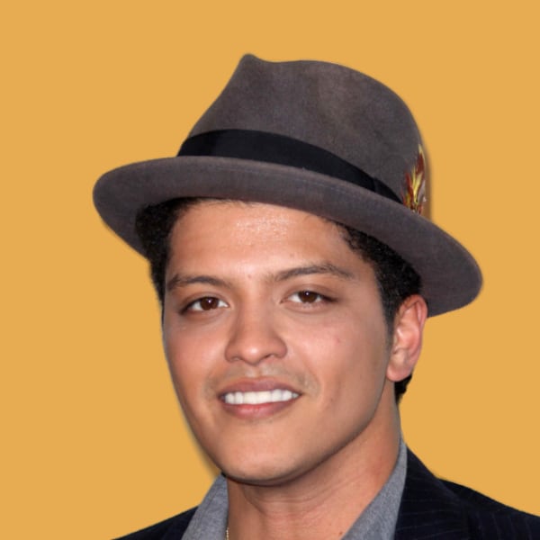 a man in a suit and hat smiling at the camera.