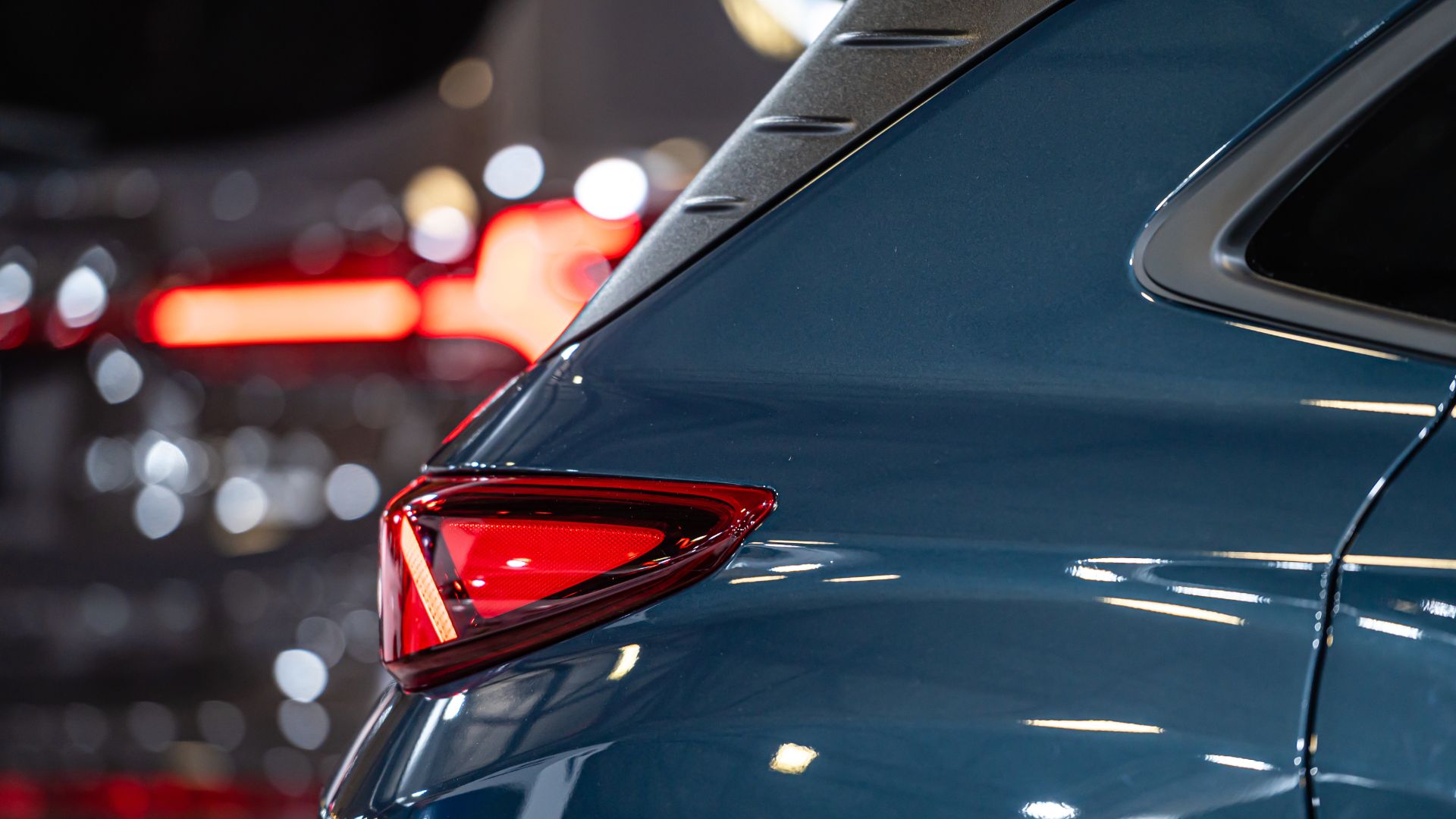 a close up of the tail lights of a blue car.
