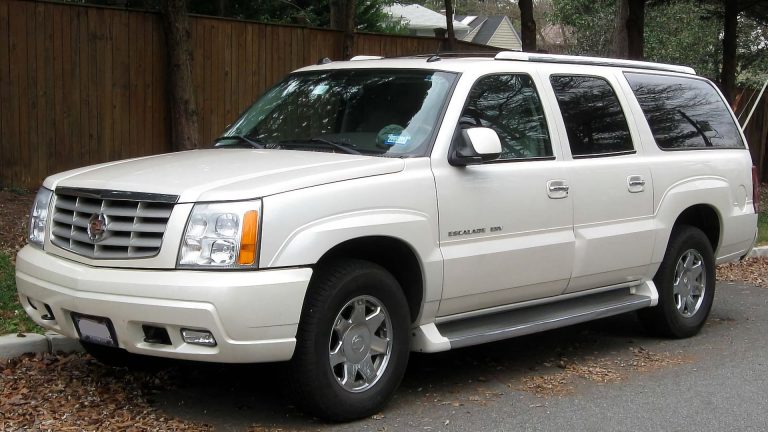 a white suv parked on the side of the road.