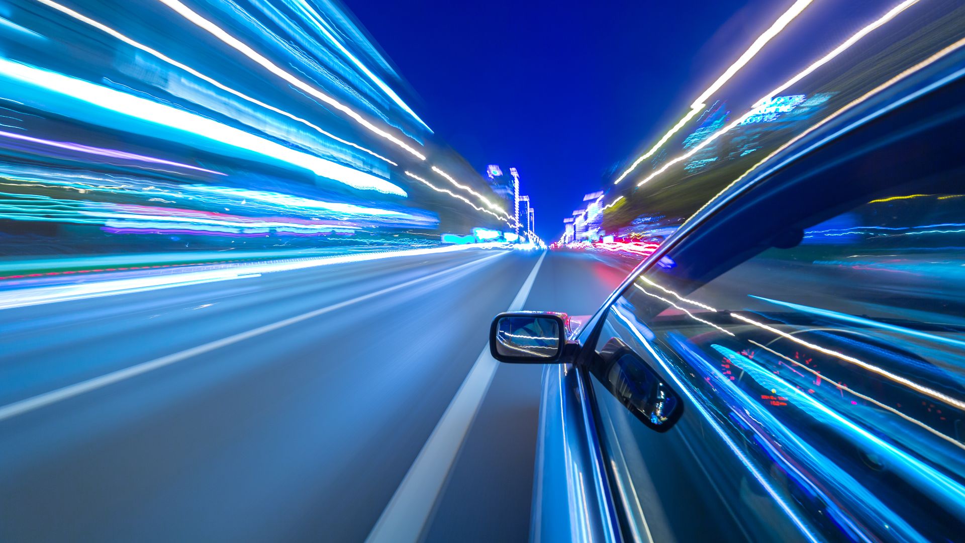 a car driving down a street at night.