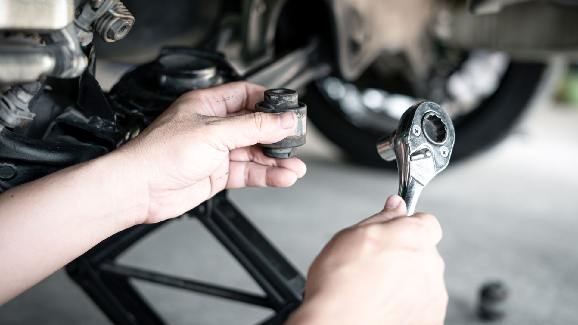 a close up of a person holding a wrench.